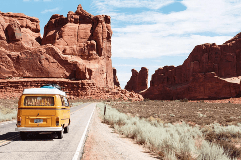 Van driving through desert landscape