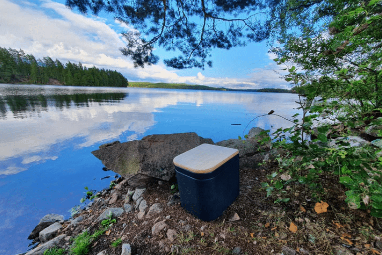 Composting toilet next to a fresh lake