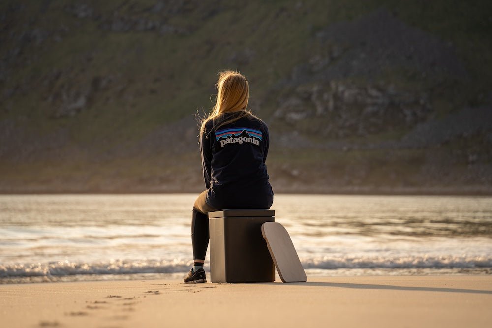Woman sitting on compost toilet at beach