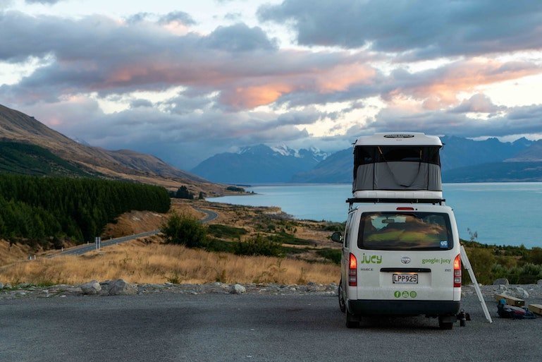 van parked in front of beautiful scenery