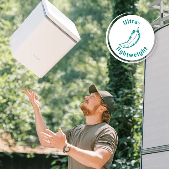 Large lightweight camping toilet being held by camper