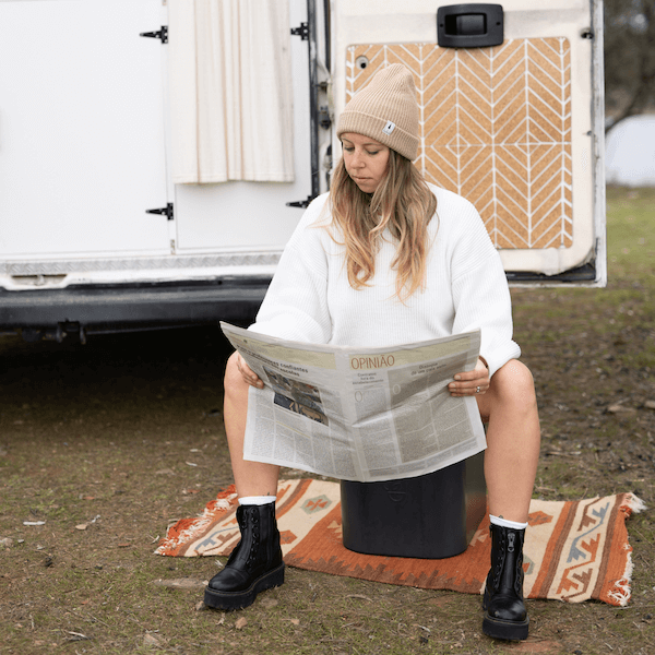woman sitting on Trelino Origin L and reading newspaper